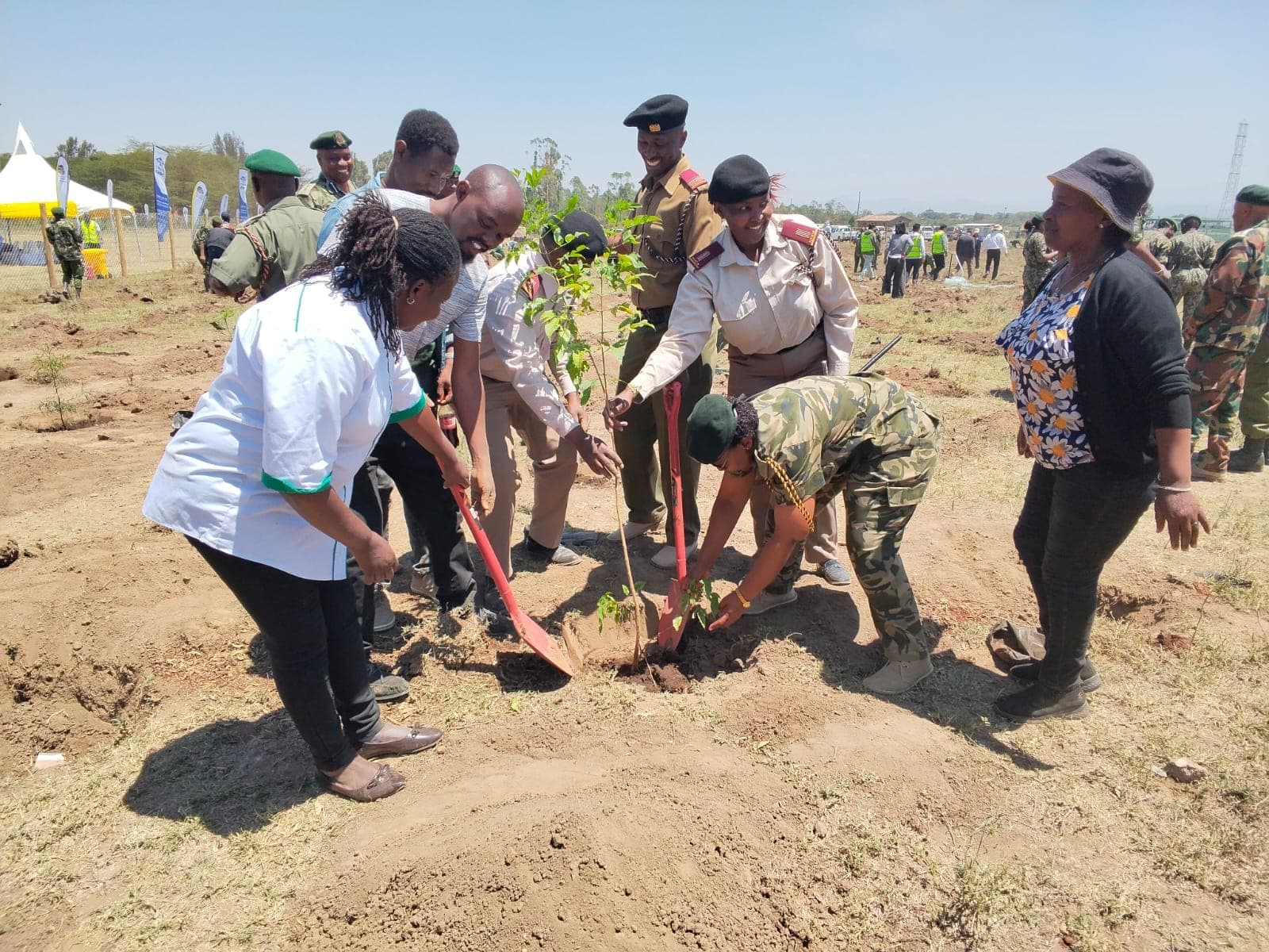 Team Climate Change Naivasha members and participants plant tree seedlings at Naivasha Medium Prison.